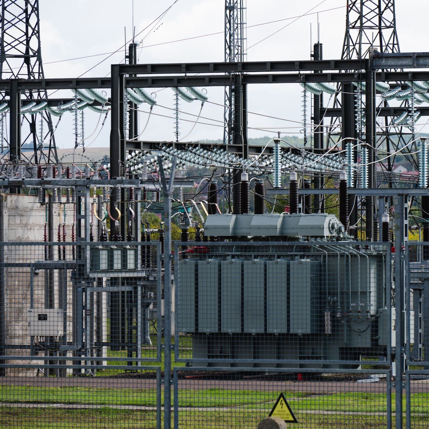 Electric power transformer station with high-voltage equipment, wires, and transmission lines